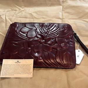 Beautiful floral embossed wristlet by Patricia Nash